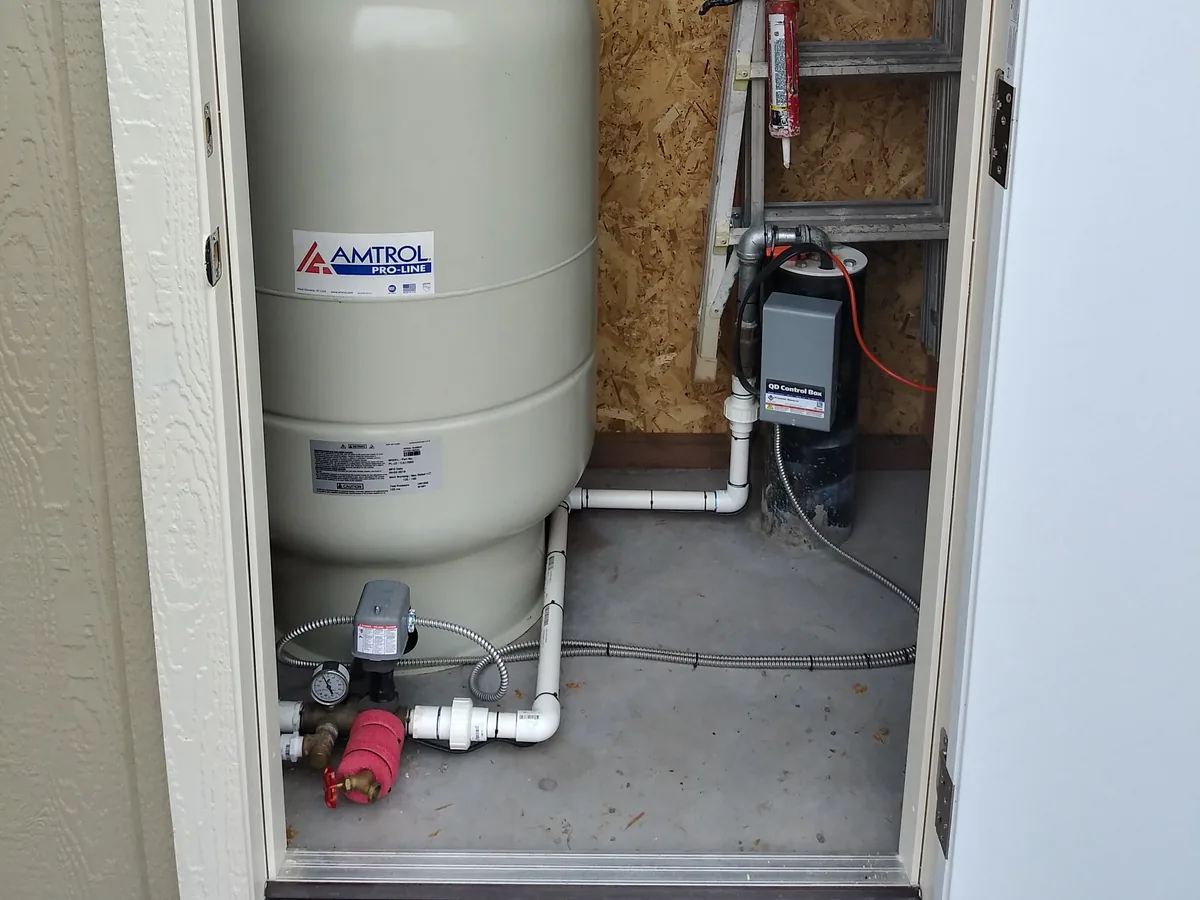 Bladder pressure tank plumbed to a tank tee with pressure gauge, pressure switch and pump control box