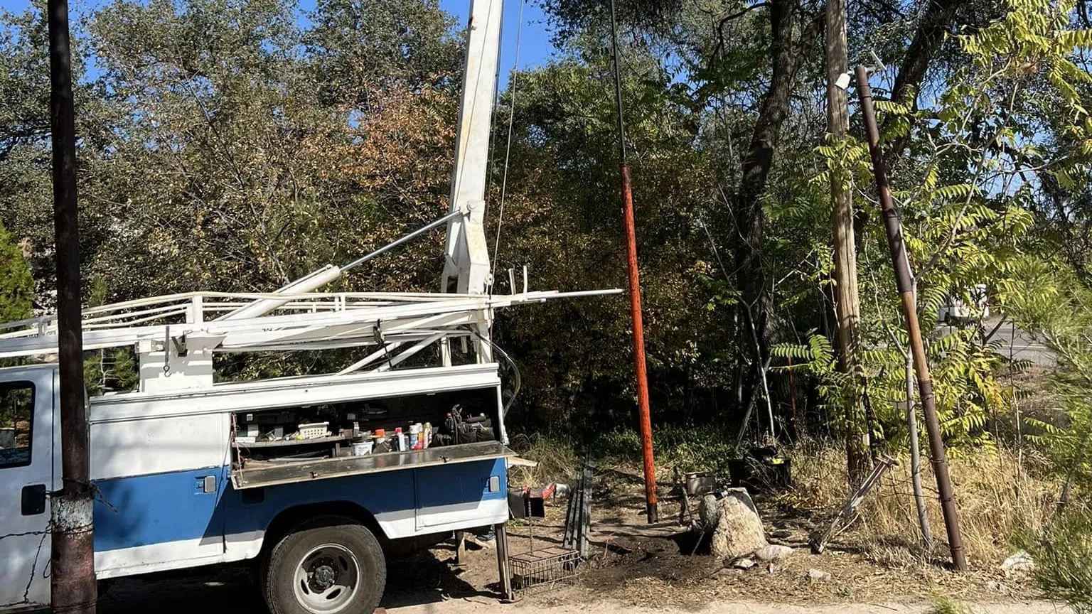 Pump hoist truck with its mast up on a well job in the Arizona high desert