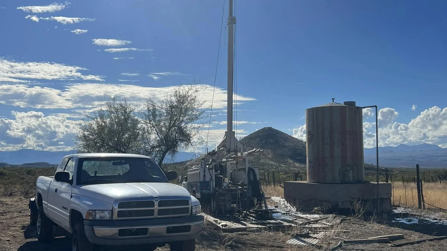 Pump hoist rig and storage tank at a well test in the San Carlos area of Arizona