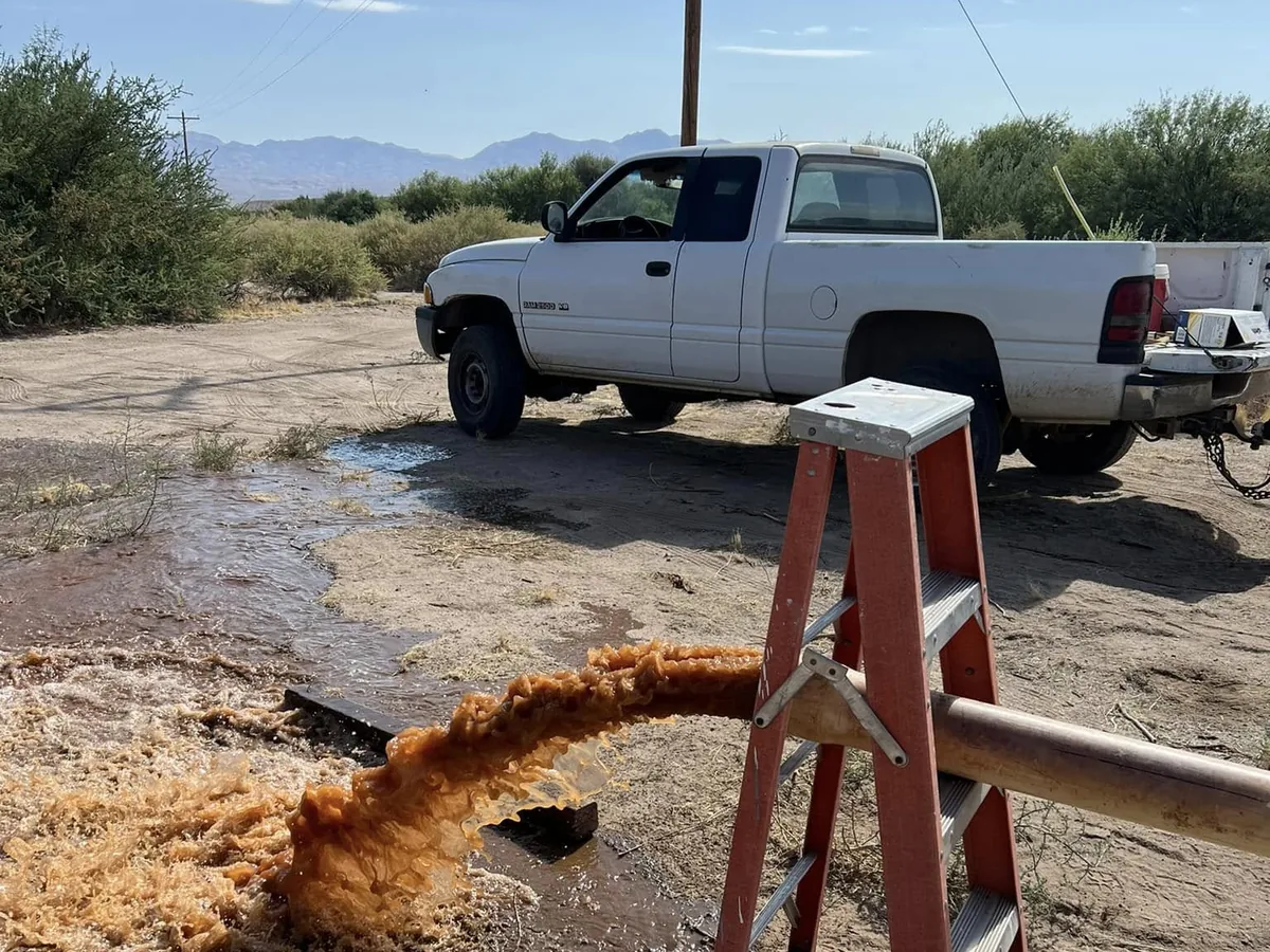 Rust-coloured water discharging from the test pipe while a well clears up