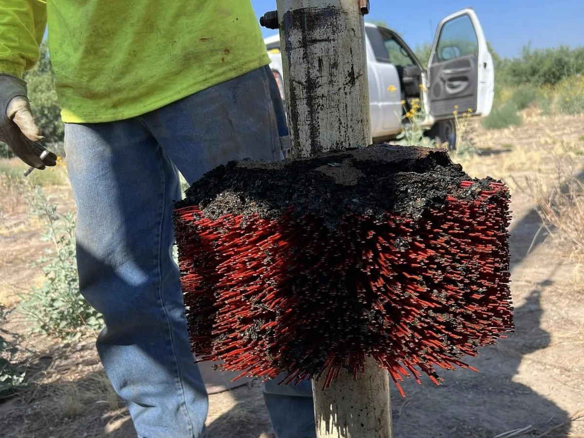 Well brush coming back up out of the casing after brushing a water well