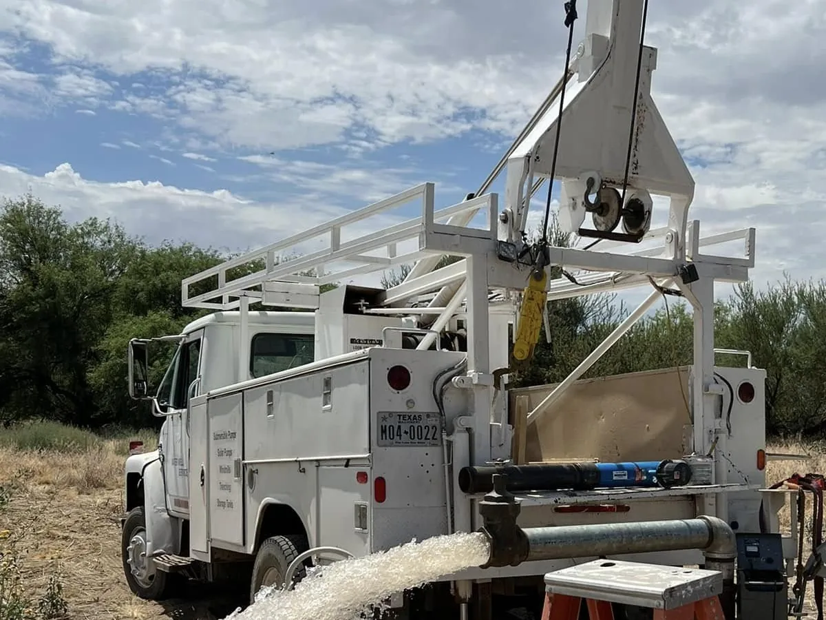 Clean water running from the discharge pipe during a well pump test